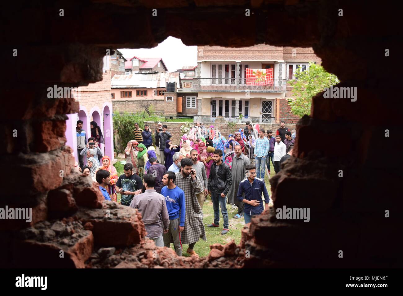 May 5, 2018 - Srinagar, Jammu & Kashmir, India - People gathered near the Encounter site in Srinagar.4 Killed and several injured in an encounter between Indian forces and militants at chatabal area of Srinagar summer capital of Indian Kashmir on Saturday. Three militants were killed during a brief shootout after government forces laid seige around densely populated chatabal area of Srinagar. A young man also died after he was hit by the armoured vehicle during the clashes between the residents and police force as residents tried to help the Militants in escape. (Credit Image: © Abbas Idrees/ Stock Photo
