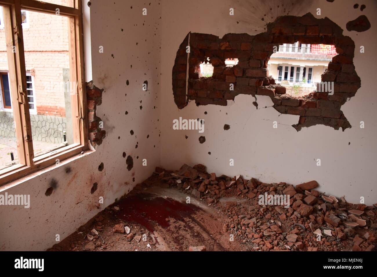 May 5, 2018 - Srinagar, Jammu & Kashmir, India - Damaged parts of Encounter site in Srinagar.4 Killed and several injured in an encounter between Indian forces and militants at chatabal area of Srinagar summer capital of Indian Kashmir on Saturday. Three militants were killed during a brief shootout after government forces laid seige around densely populated chatabal area of Srinagar. A young man also died after he was hit by the armoured vehicle during the clashes between the residents and police force as residents tried to help the Militants in escape. (Credit Image: © Abbas Idrees/SOPA Ima Stock Photo