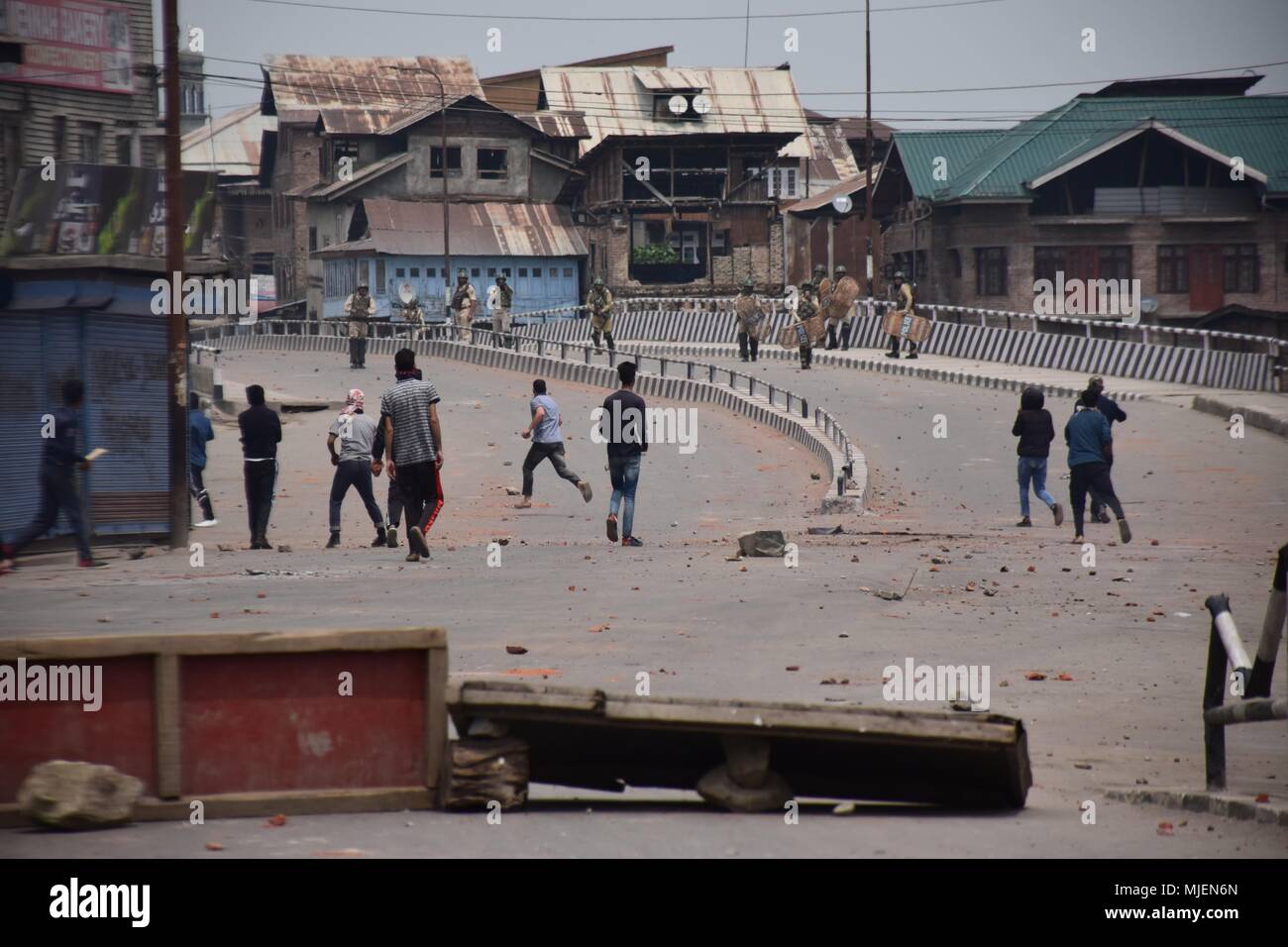 May 5, 2018 - Srinagar, Jammu & Kashmir, India - People clashes with forces near the Encounter site in Srinagar.4 Killed and several injured in an encounter between Indian forces and militants at chatabal area of Srinagar summer capital of Indian Kashmir on Saturday. Three militants were killed during a brief shootout after government forces laid seige around densely populated chatabal area of Srinagar. A young man also died after he was hit by the armoured vehicle during the clashes between the residents and police force as residents tried to help the Militants in escape. (Credit Image: © Ab Stock Photo