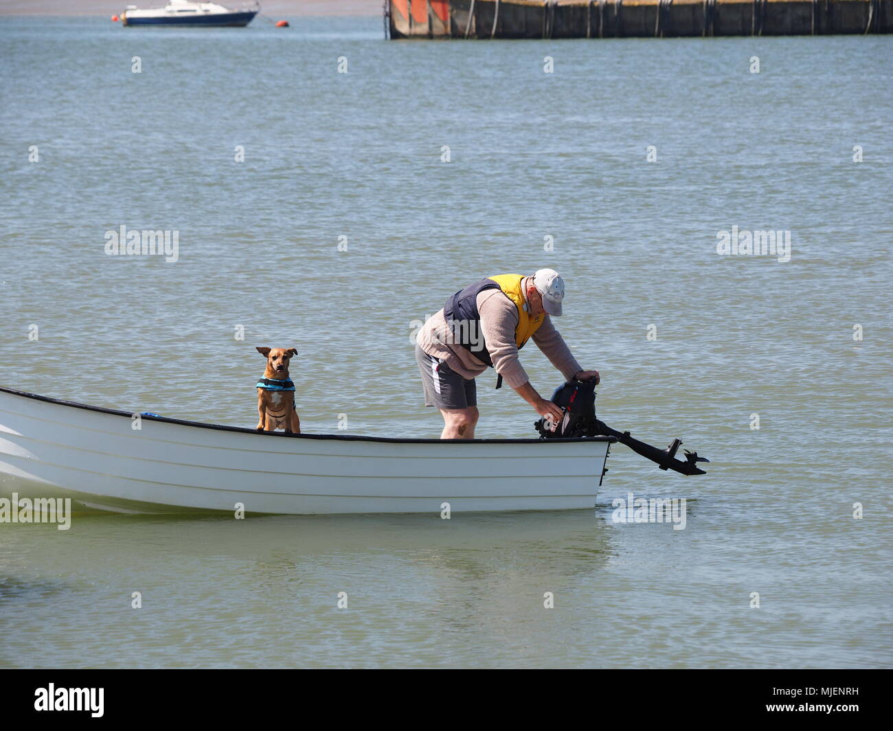 Queenborough, Kent, UK. 5th May, 2018. UK Weather: a sunny and warm day in Queenborough, Kent. A man ferries his dog in a tender. Credit: James Bell/Alamy Live News Stock Photo