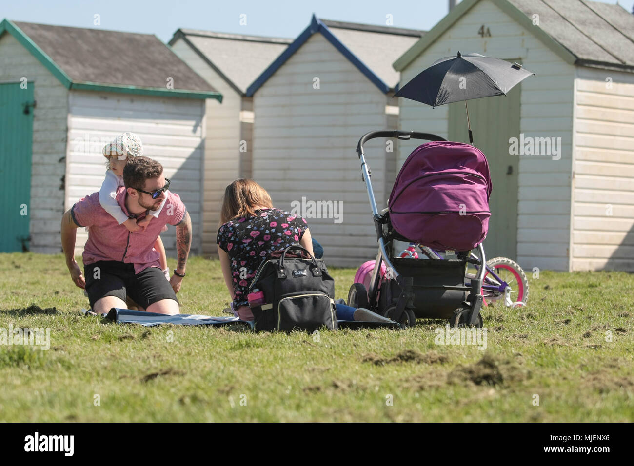 A family enjoy the sunny day on Paignton seafront. Stock Photo