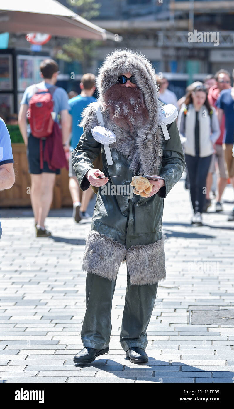 Brighton UK 5th May 2018  - Dressed more for the Antarctic this Brighton Festival performer braves the hot sunshine in Brighton today with temperatures forecast to reach the high twenties in some parts of the South East and set fair to continue over the bank holiday weekend Credit: Simon Dack/Alamy Live News Stock Photo