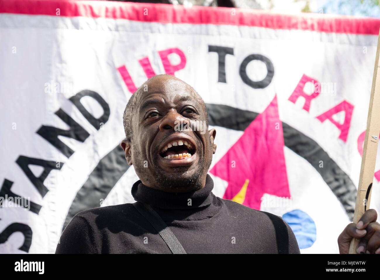 London, UK, 5th May 2018, Demonstrators attend a march for Windrush opposite Downing Street in an attempt to overturn the governments immigration policy stating Theresa May's current policy is racist. Weyman Bennett of the stand up to racism organisation gives a speech to the attendees Credit: adrian looby/Alamy Live News Stock Photo