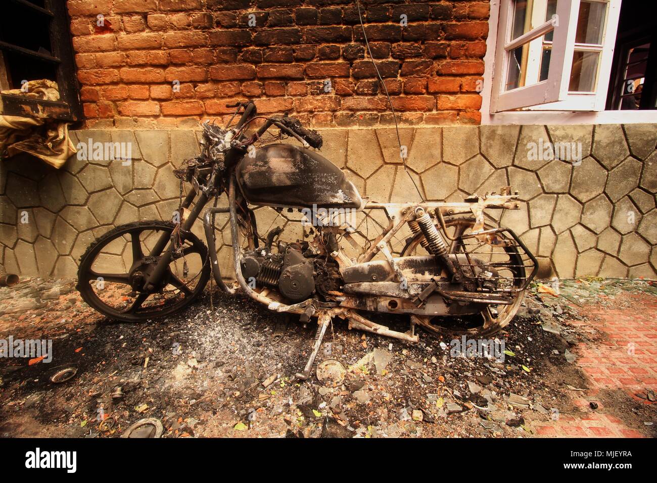 May 5, 2018 - Srinagar, Jammu and Kashmir, India - SRINAGAR, KASHMIR, INDIA-MAY 05: A motorcycle damaged during the gun-battle is seen in Srinagar the summer of Indian controlled Kashmir on May 05, 2018. Four people including a protester and three rebels were killed during a gun-battle between rebels and Indian forces in Chattabal area of Srinagar. Massive clashes erupt across Srinagar after the news about the trapping of rebels and killing of protester spread across the city. Police fired teargas canisters, pellets, stun grenades and rubber coated bullets to disperse the angry crowd. (Credit Stock Photo