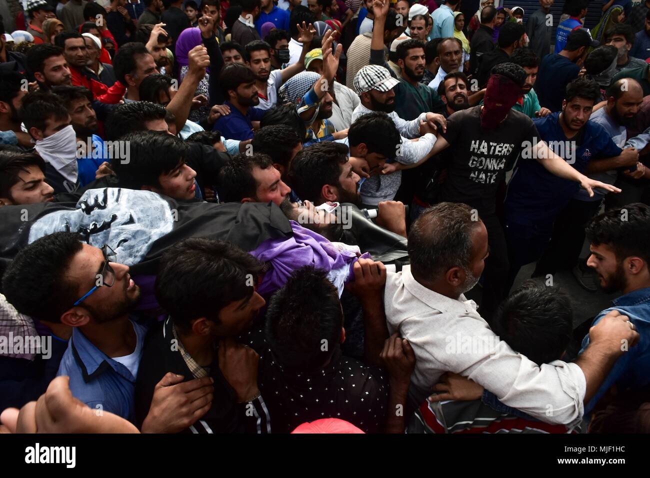 Kashmir, India, 5 May 2018.  (EDITORS NOTE: Image depicts death.) Kashmiri residents carry the body of Adil Ahmad, a civilian who was run over and killed by a security force vehicle, during his funeral procession in Srinagar, Indian administered Kashmir. Three suspected militants and one civilian have been killed while three Indian paramilitary men sustained injuries in a gun battle in Srinagar, the summer capital of Indian administered Kashmir. The encounter started after government forces cordoned off a Chattabal area following the presence of militants in the area, officials said. Credit: Z Stock Photo