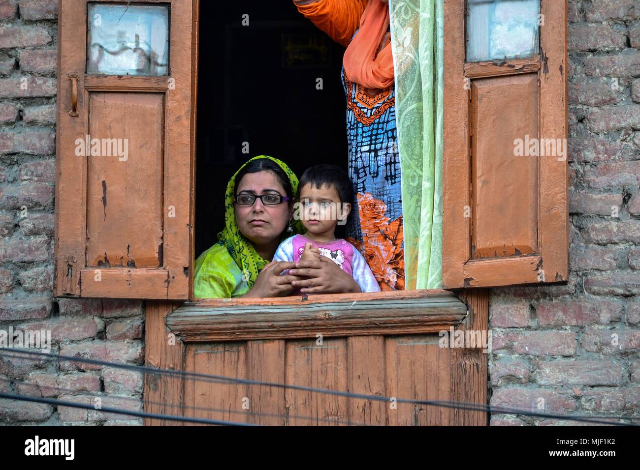 Kashmir, India, 5 May 2018.  Kashmiri locals watch the funeral procession of Adil Ahmad, a civilian who was run over and killed by a security force vehicle, during his funeral procession in Srinagar, Indian administered Kashmir. Three suspected militants and one civilian have been killed while three Indian paramilitary men sustained injuries in a gun battle in Srinagar, the summer capital of Indian administered Kashmir. The encounter started after government forces cordoned off a Chattabal area following the presence of militants in the area, officials said. More than 2 houses were d Credit: Z Stock Photo