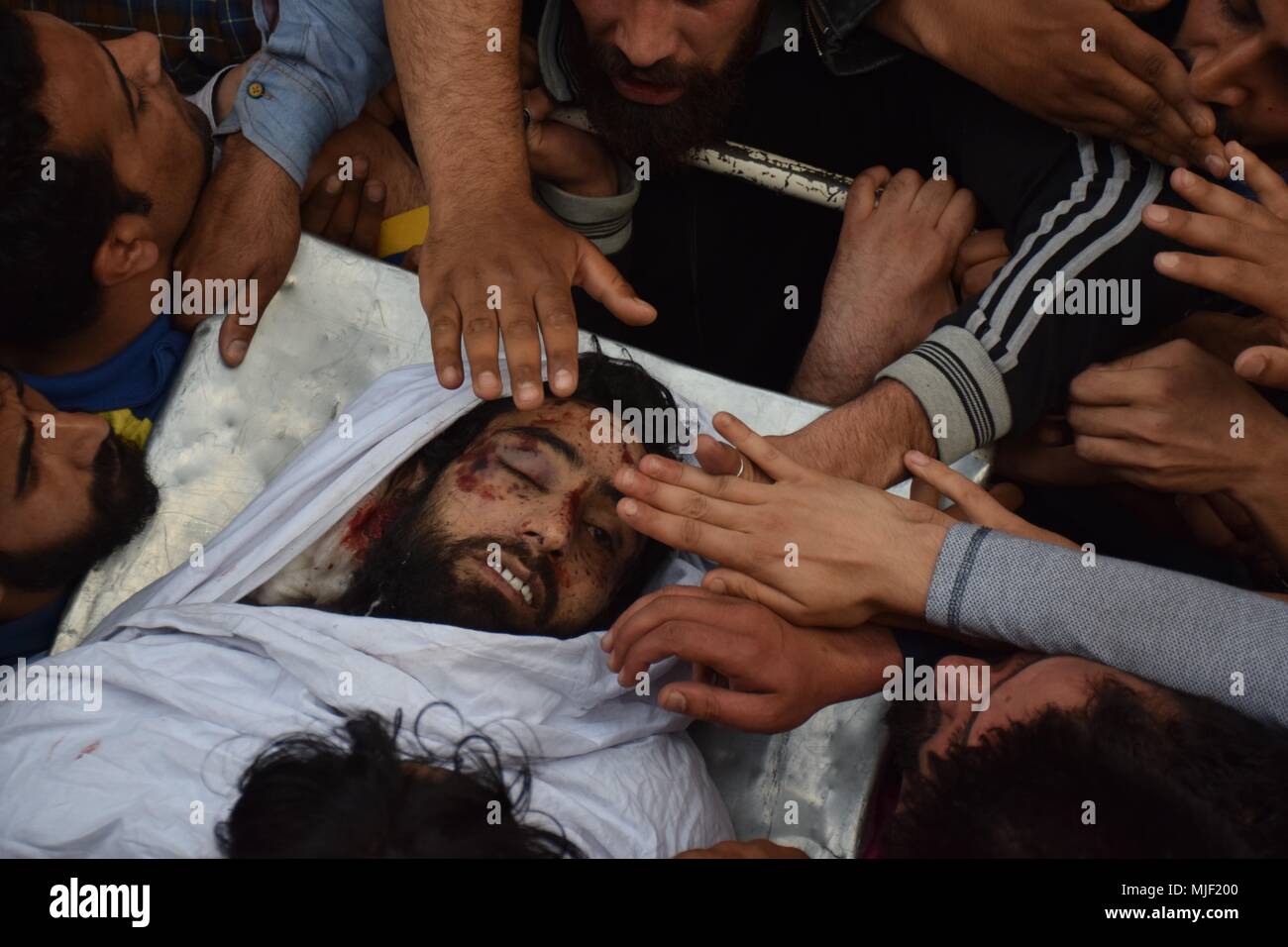 Srinagar, Jammu & Kashmir, India, May 5, 2018.  (EDITORS NOTE: Image depicts death.).People touches the face of Militant Fayaz Ahmed Hamal during his funeral procession at his residence in Srinagar.Multiple Funeral processions held in srinagar summer capital of Indian Kashmir on Saturday of Fayaz Ahmed Hamal a LeT (Lashkar-e-Taiba) Militant and a Civilian Adil Ahmed Yatoo who were killed by armoured vehicle on Saturday during clashes near Encounter site.litant at their residence. 4 Killed Credit: ZUMA Press, Inc./Alamy Live News Stock Photo