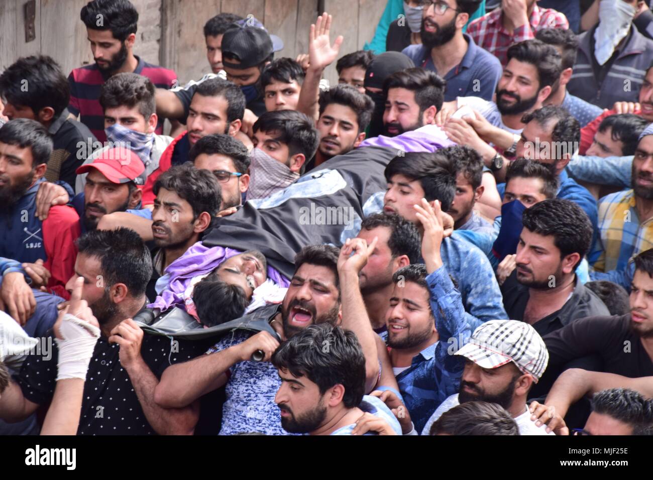 Srinagar, Jammu & Kashmir, India, May 5, 2018.  (EDITORS NOTE: Image depicts death.).People carrying the body of civilian Adil Ahmed Yatoo who got killed by armoured vehicle during clashes near Encounter site for burial During his funeral procession in Srinagar summer capital of Kashmir.Multiple Funeral processions held in srinagar summer capital of Indian Kashmir on Saturday of Fayaz Ahmed Hamal a LeT (Lashkar-e-Taiba) Militant and a Civilian Adil Ahmed Yatoo who were killed by armoured vehicle on Saturday during clashes near Encounter site. child Credit: ZUMA Press, Inc./Alamy Live News Stock Photo