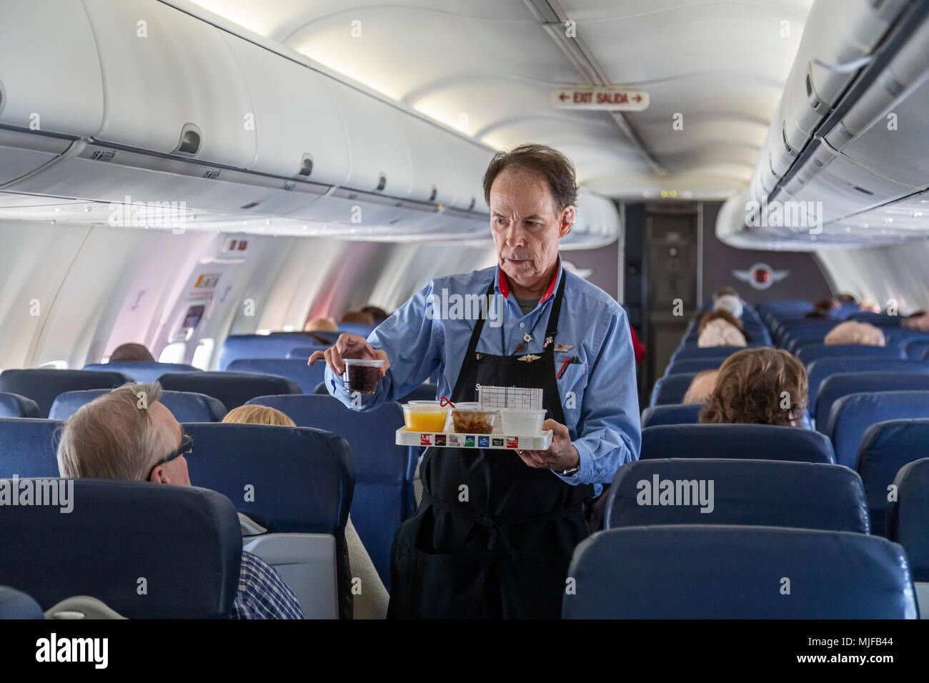 Detroit, Michigan - A flight attendant serves drinks on a Southwest Airlines flight from Detroit to Atlanta. Stock Photo