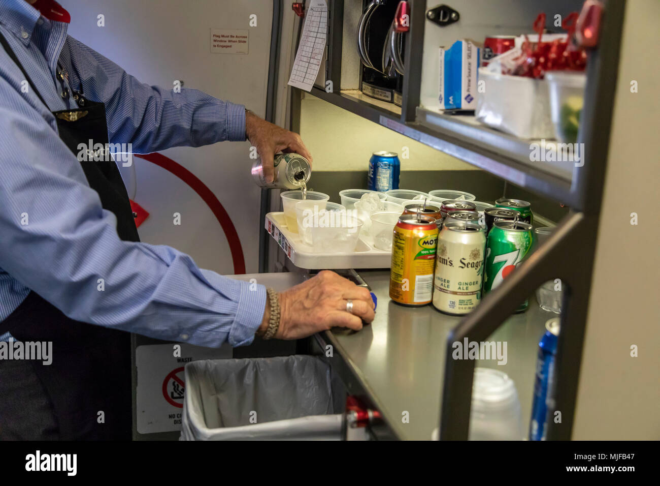 Detroit, Michigan - A flight attendant pours drinks for passengers on a Southwest Airlines flight from Detroit to Atlanta. Stock Photo