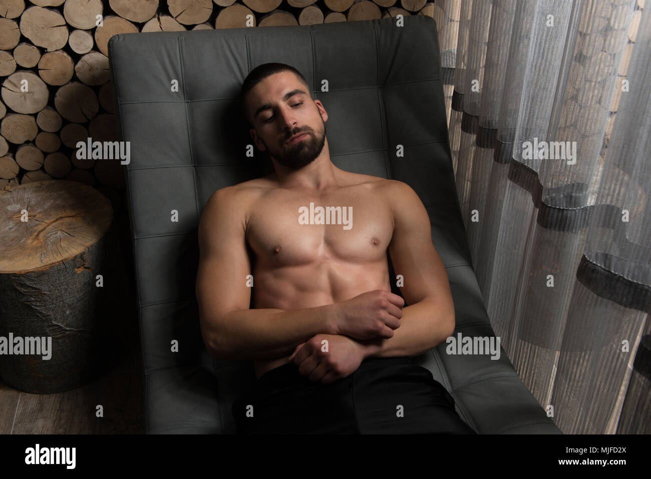 Handsome Good Looking And Attractive Young Man With Muscular Body Relaxing Stock Photo