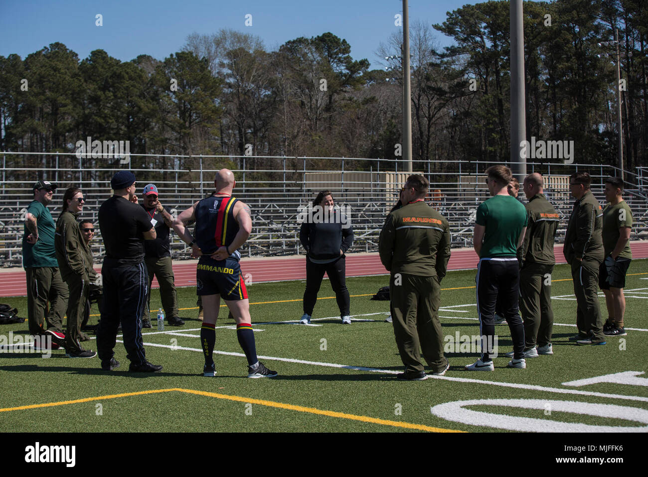 2018 Marine Corps Trials participants talk to their coach during a track practice at Marine Corps Base Camp Lejeune, N.C., March 15, 2018. The Marine Corps Trials promotes recovery and rehabilitation through adaptive sport participation and develops camaraderie among recovering service members (RSMs) and veterans. It is an opportunity for RSMs to demonstrate their achievements and serves as the primary venue to select Marine Corps participants for the DoD Warrior Games. (U.S. Marine Corps Stock Photo