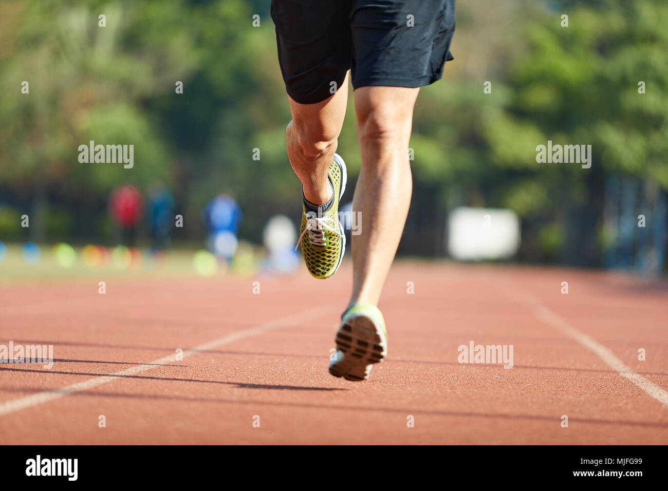 young asian man male athlete running training exercising on track. Stock Photo