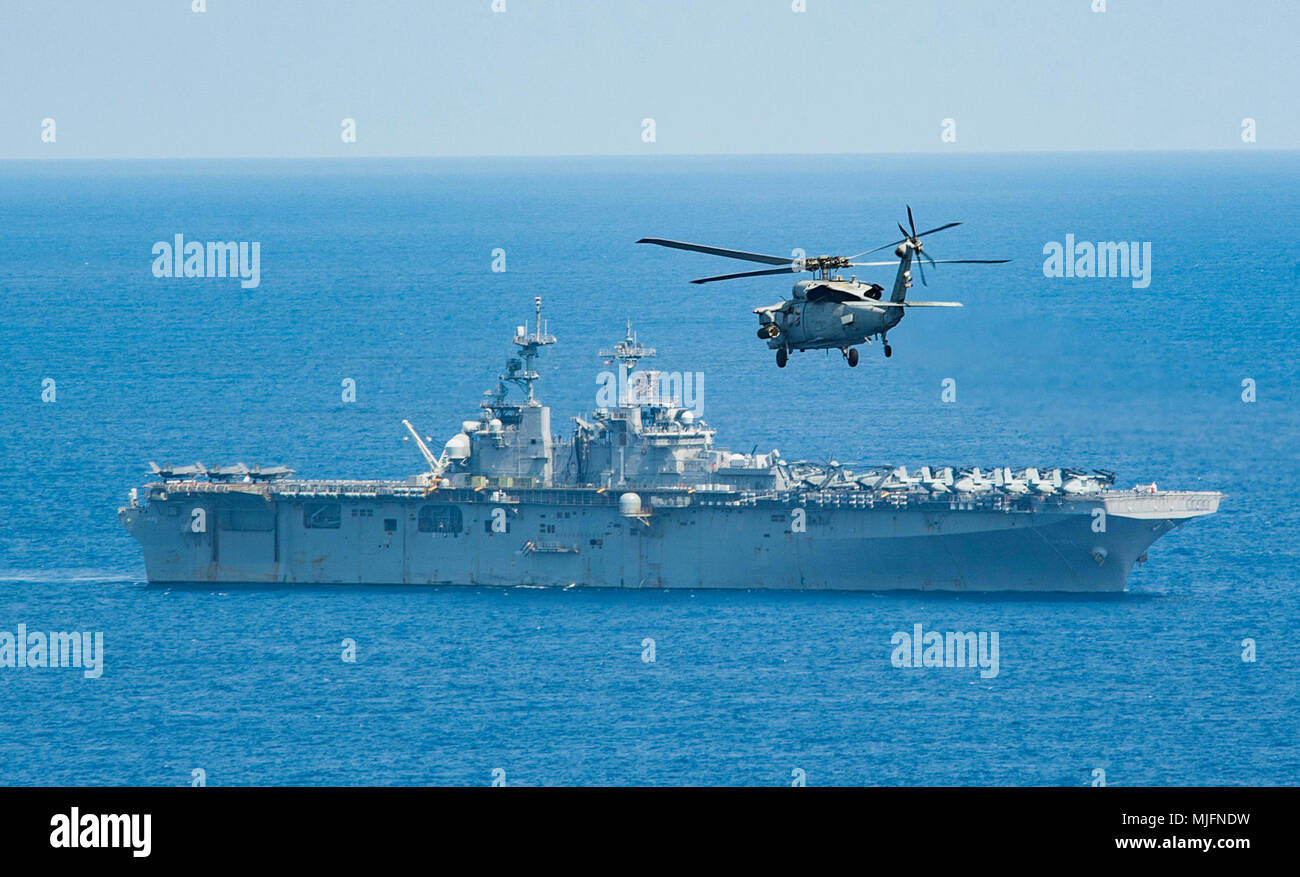 PHILIPPINE SEA(March 20, 2018) An MH-60S Sea Hawk attached to Helicopter Sea Combat Squadron (HSC) 25 approaches the amphibious assault ship USS Wasp (LHD 1). Wasp, part of the Wasp Expeditionary Strike Group, with embarked 31st Marine Expeditionary Unit, is operating in the Indo-Pacific region to enhance operability with partners, serve as a ready-response force for any type of contingency and advance the Up-Gunned ESG concept. (U.S. Navy Stock Photo