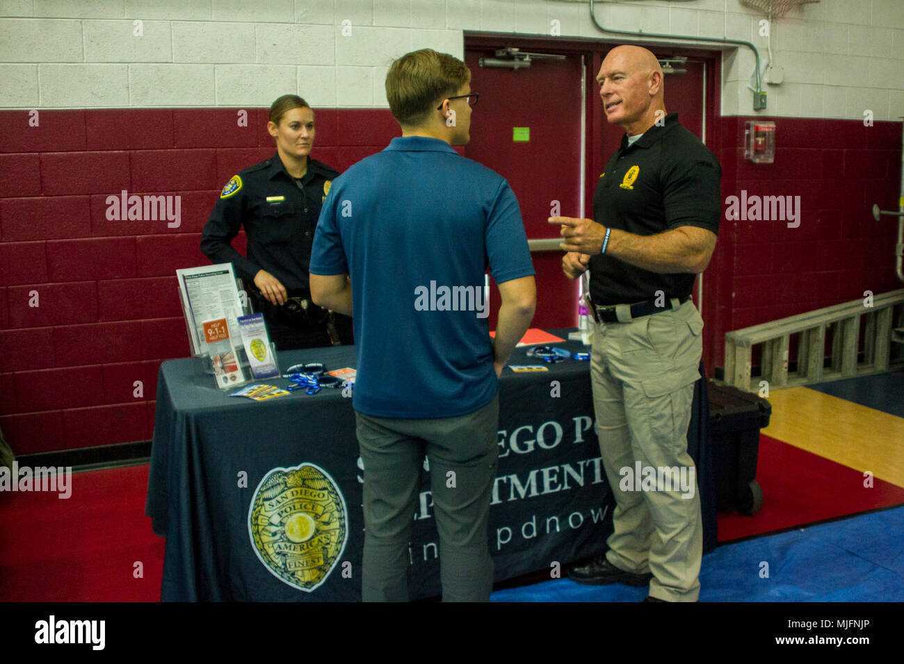 A Marine speaks to Steve Markland, police recruiter, Recruiting Unit
