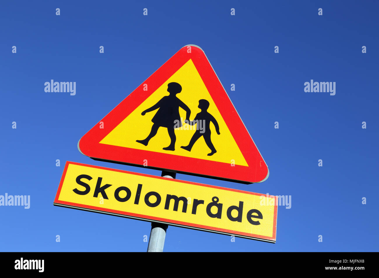 Swedish road sign against blue sky Warning for Children - School zone. Stock Photo