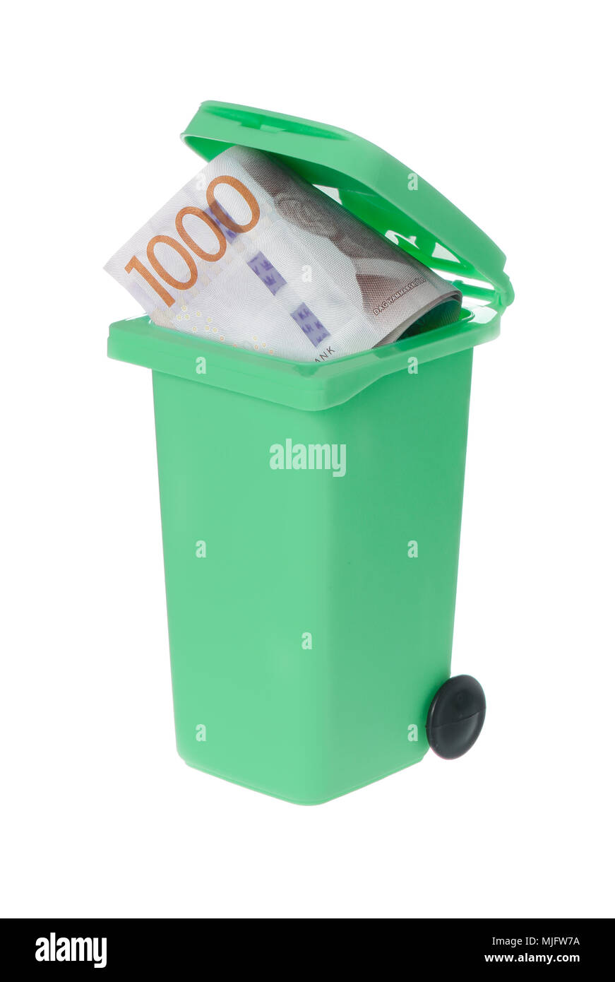 One green recycle bin with a wasted Swedish banknote 1000 krona visible inside isolated on white background. Stock Photo