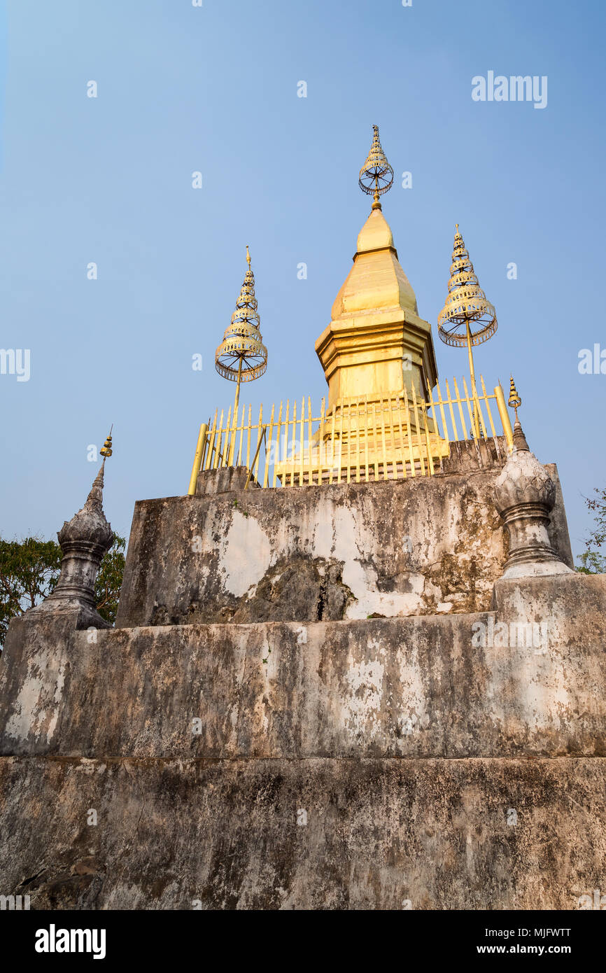 The gilded stupa of Wat Chom Si on the summit of Mount Phousi (Phou Si,  Phusi, Phu Si) in Luang Prabang, Laos, on a sunny day Stock Photo - Alamy