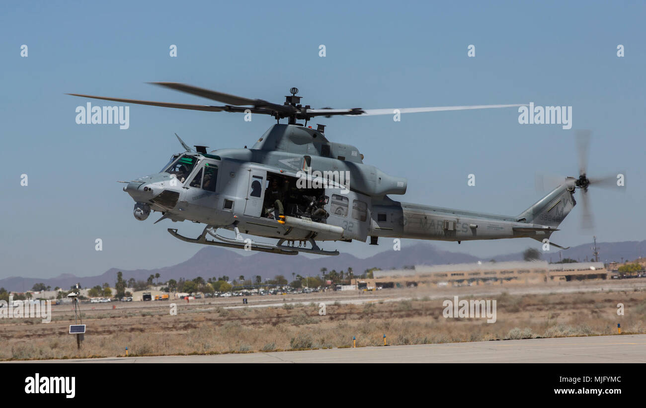 A U.S. Marine Corps UH-1Y Venom assigned to Marine Aviation Weapons and Tactics Squadron 1 takes off during an Advanced Precision Kill Weapon System loading and flight takeoff exercise in support of Weapons and Tactics Instructor course 2-18 at Marine Corps Air Station Yuma, Ariz., March 29. WTI is a seven-week training event hosted by MAWTS-1 cadre, which emphasizes operational integration of the six functions of Marine Corps aviation in support of a Marine Air Ground Task Force and provides standardized advanced tactical training and certification of unit instructor qualifications to support Stock Photo