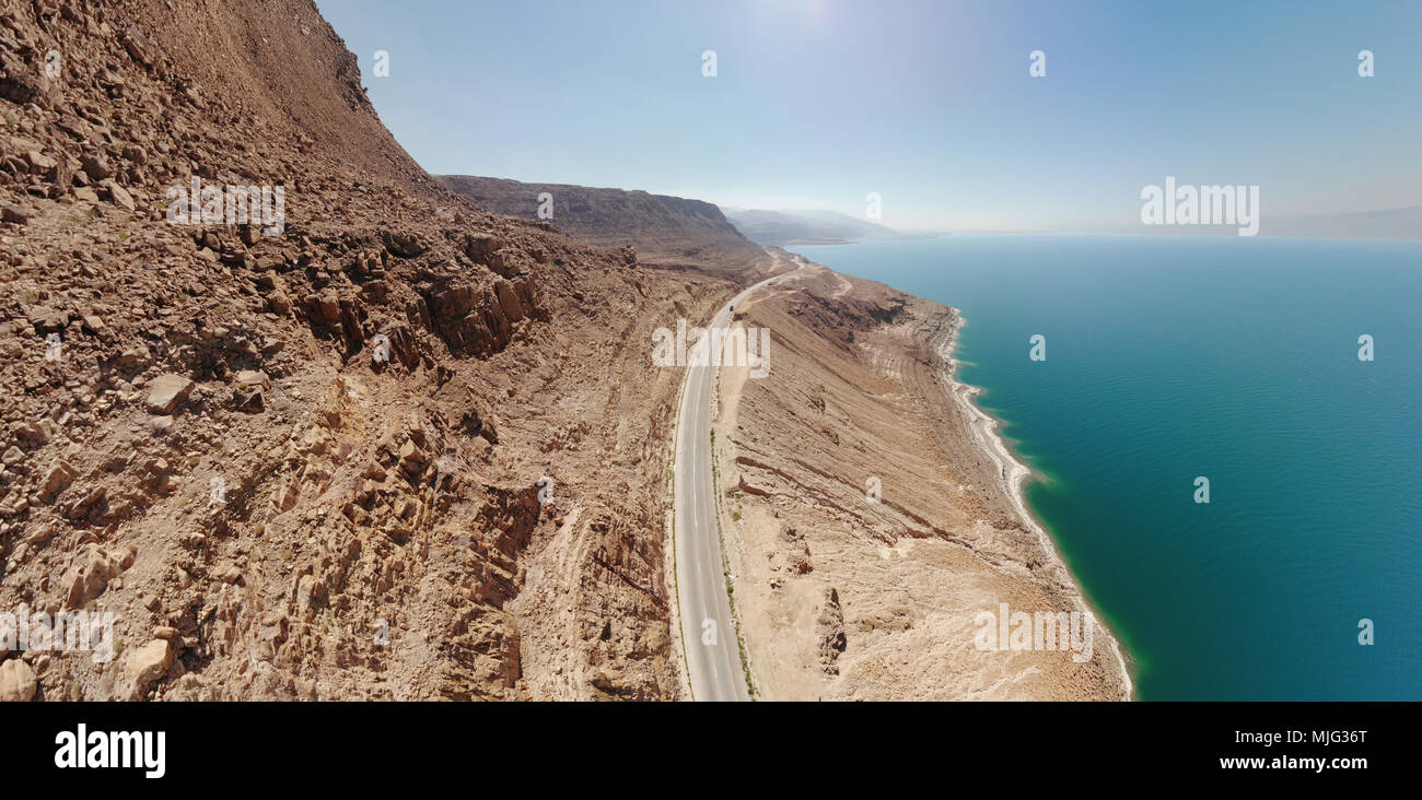 Aerial view from the main road along the Dead Sea, taken with the drone close to the rocks of the ascending mountains, Jordan Stock Photo