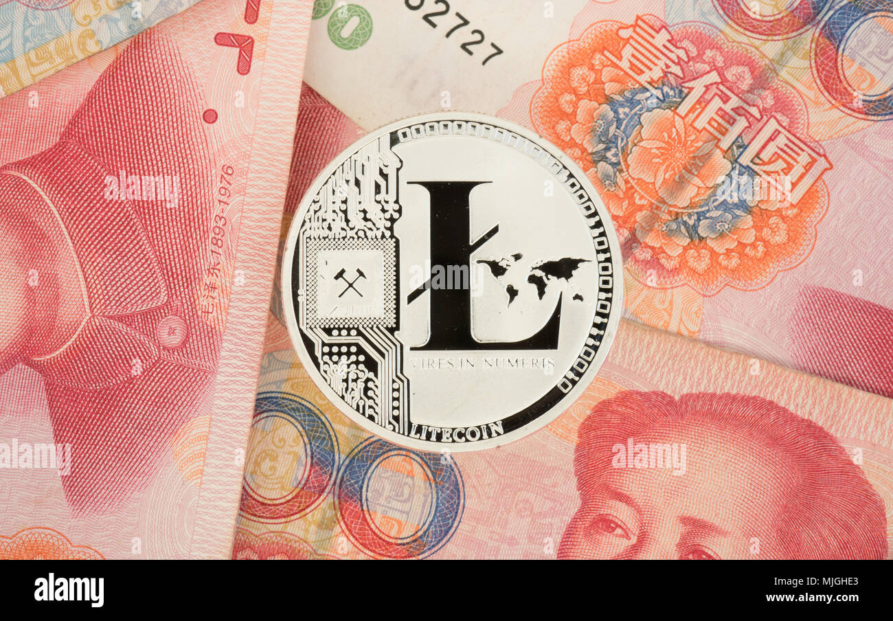 Real Litecoin coin on chinese yuan bills - crypto currency in china concept Stock Photo