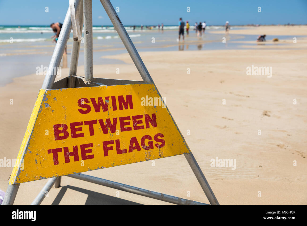 Swim between the flags - a common surf lifesaving sign on beaches in Australia promoting swimming safety Stock Photo