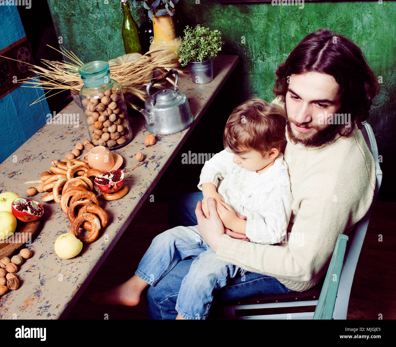 modern hipster father with little cute son on wooden country green kitchen, eating organic food, lifestyle people concept Stock Photo