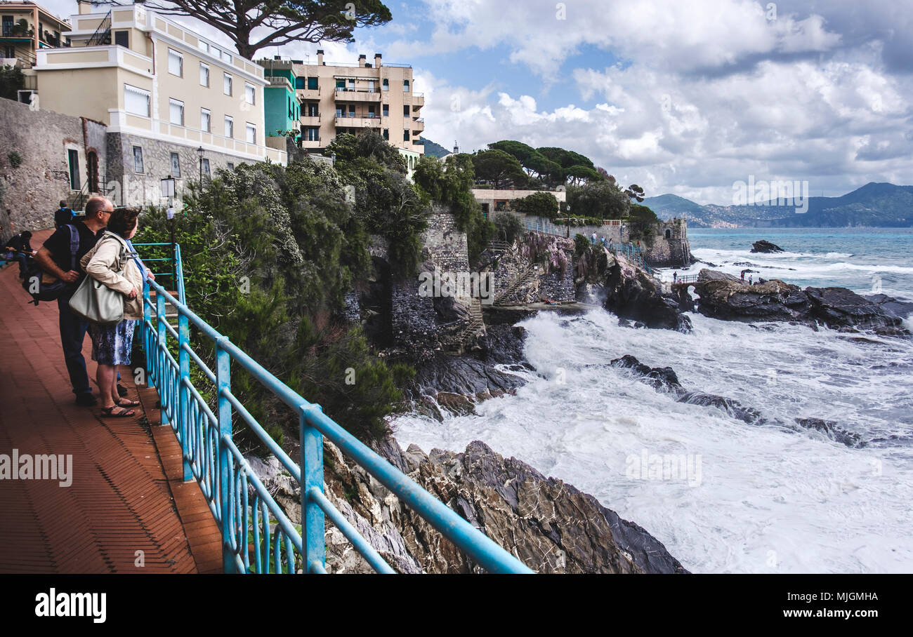 Genoa Nervi - Italy, - senior couple stormy sea coast reef rocks Stock Photo