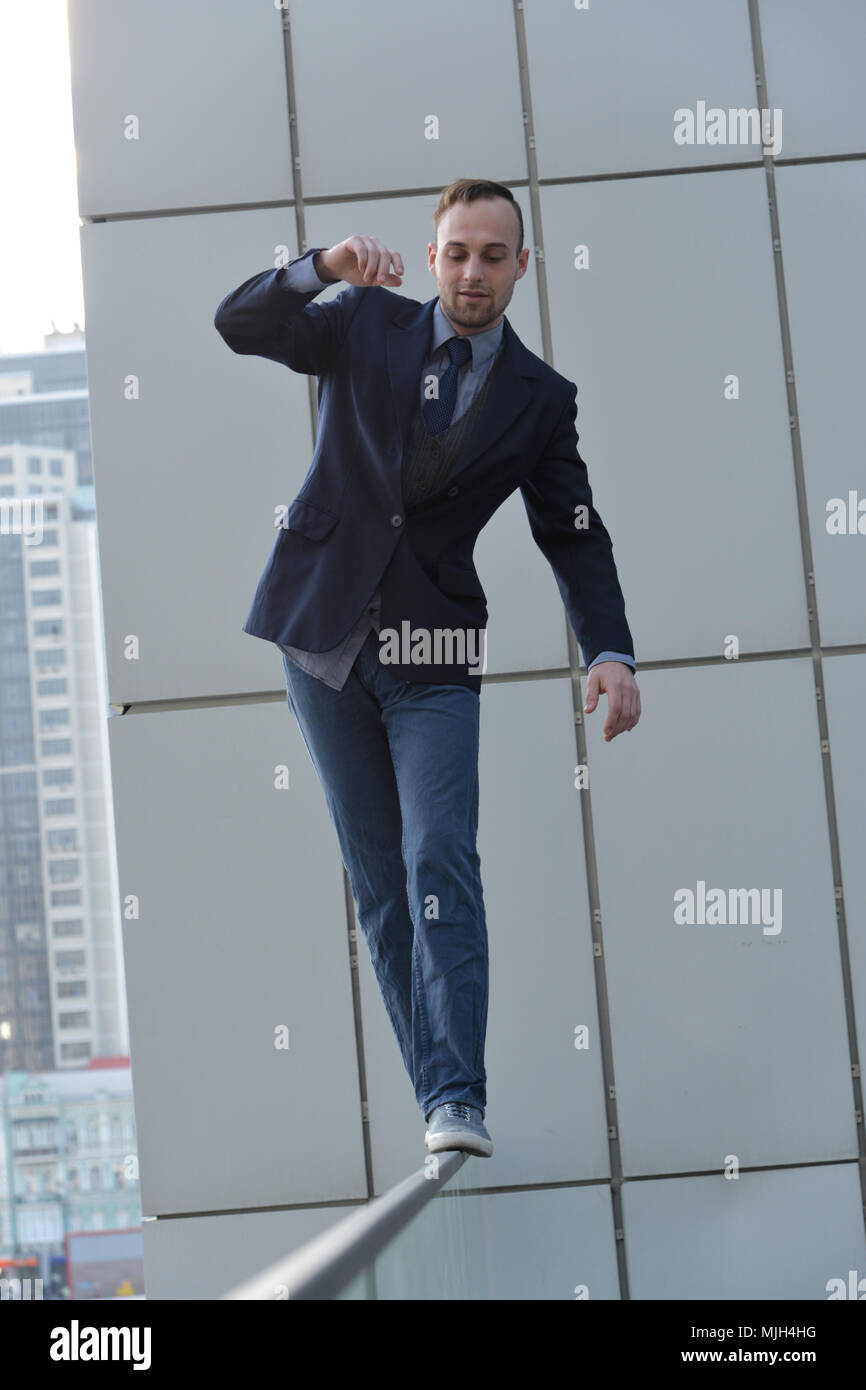 brave businessman walking along the abyss edge Stock Photo