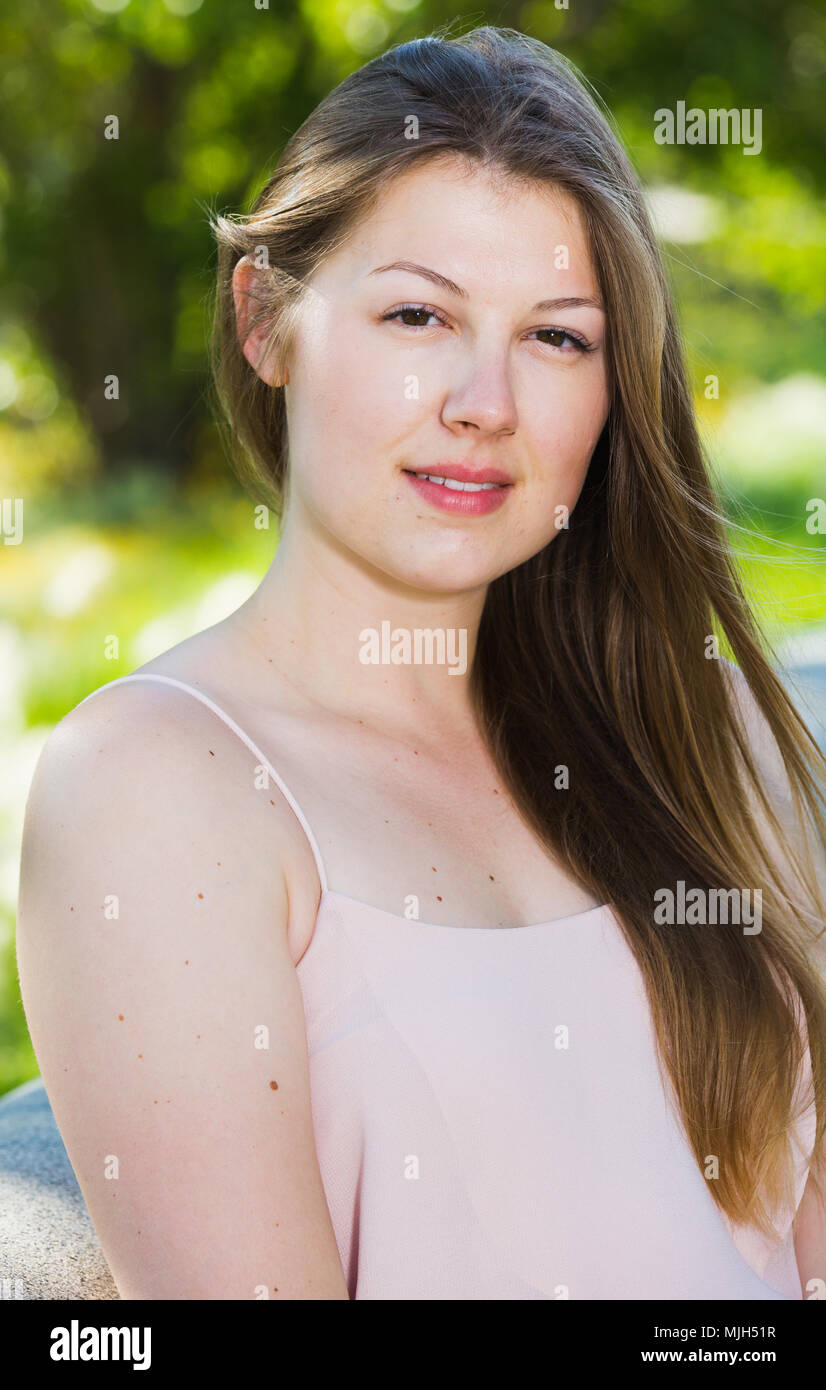 Portrait of girl which is sitting on bench in the park Stock Photo - Alamy