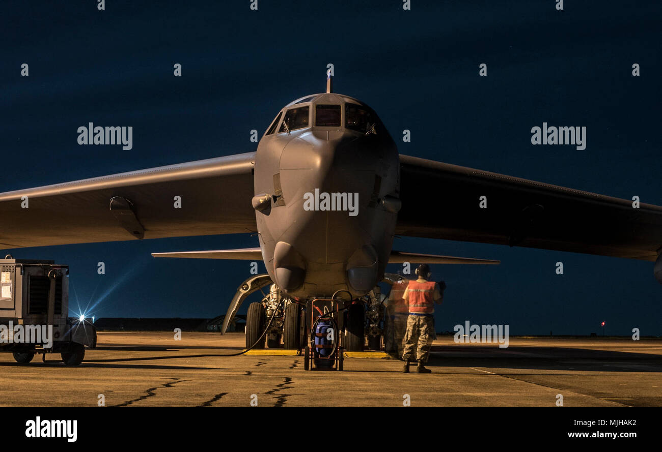 A crew chief assigned to the 20th Expeditionary Aircraft Maintenance Unit prepares a B-52H Stratofortress for an early morning take-off at Royal Australian Air Force (RAAF) Base, Darwin, Australia, April 2, 2018. A detachment of U.S. Air Force B-52H bombers, aircrew and support personnel deployed to RAAF Darwin to enable the U.S. to train and increase interoperability with Australian joint terminal attack controllers as part of the U.S. Force Posture Initiatives’ Enhanced Air Cooperation program, which builds on air exercises and training between the two air forces. The bombers are currently a Stock Photo