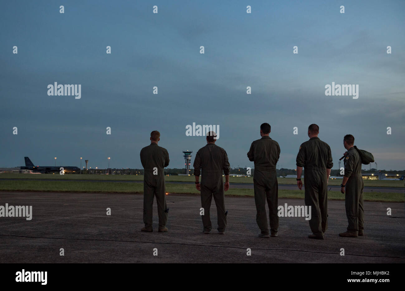 Aircrew members assigned to the 20th Expeditionary Bomb Squadron watch as their team members take off in a B-52H Stratofortress at Royal Air Force (RAAF) Base Darwin, Australia, April 3, 2018. The aircrews deployed to Darwin to partake in the Enhanced Air Cooperation  (EAC) exercises with RAAF aircraft and joint terminal attack controllers. These exercises enhance U.S. ability to integrate with Australian troops and partners across the region. The EAC initiative, codified in 2014 by signature between the U.S. Secretary of Defense, U.S. Secretary of State and their Australian counterparts, fost Stock Photo