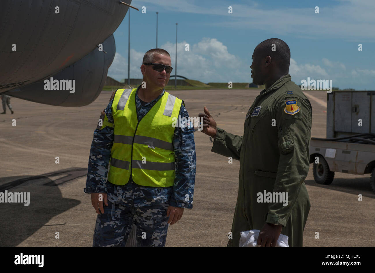 U.S. Air Force Capt. Joseph Okai Jr., 20th Expeditionary Bomb Squadron B-52H Stratofortress pilot, (right) explains features of the bomber to a member of the Royal Australian Air Force (RAAF) at RAAF Base Darwin, Australia, April 4, 2018. A detachment of U.S. Air Force B-52H bombers, aircrew and support personnel deployed to RAAF Darwin to train and increase interoperability with Australian joint terminal attack controllers as part of the U.S. Force Posture Initiatives’ Enhanced Air Cooperation program, which builds on air exercises and training between the two air forces. The bombers are curr Stock Photo