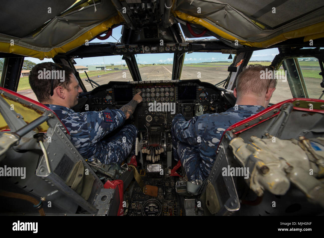 Royal Australian Air Force (RAAF) Flight Lieutenant Christian Pace (left), and Flying Officer Ben Rowe, both air traffic controllers assigned to 452nd Squadron, explore the cockpit of a B-52H Stratofortress at RAAF Base Darwin, Australia, April 6, 2018. A detachment of U.S. Air Force B-52H bombers, aircrew and support personnel deployed to RAAF Darwin to enable the U.S. to train and increase interoperability with Australian joint terminal attack controllers as part of the U.S. Pacific Command’s Enhanced Air Cooperation program, which builds on air exercises and training between the two air for Stock Photo