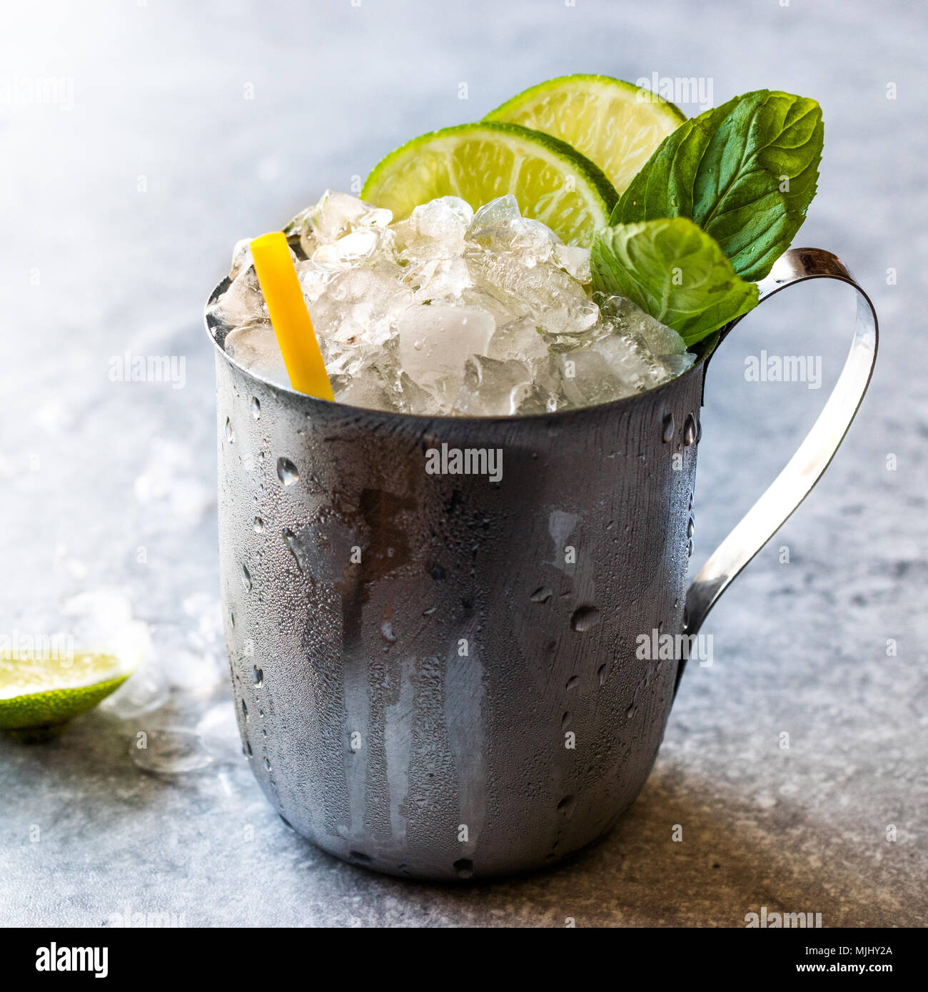 Moscow Mule Cocktail with Lime, Mint Leaves and Crushed Ice in Metal Cup. Summer Beverage Stock
