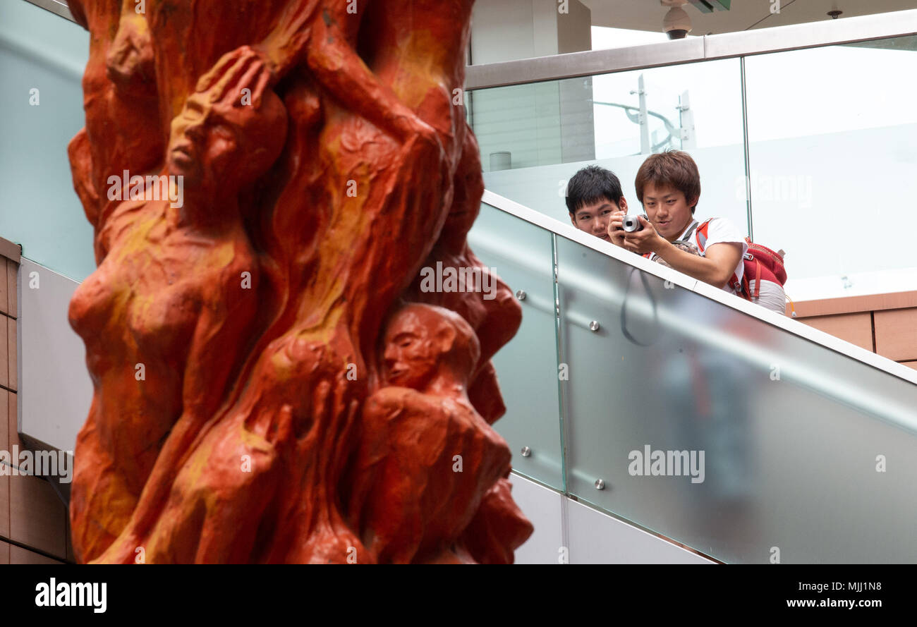 Annual cleaning of Danish artist Jens Galschiot's 'Pillar of Shame' at Hong Kong University Pok Fu Lam Hong Kong. The sculpture is a memorial to the 1 Stock Photo