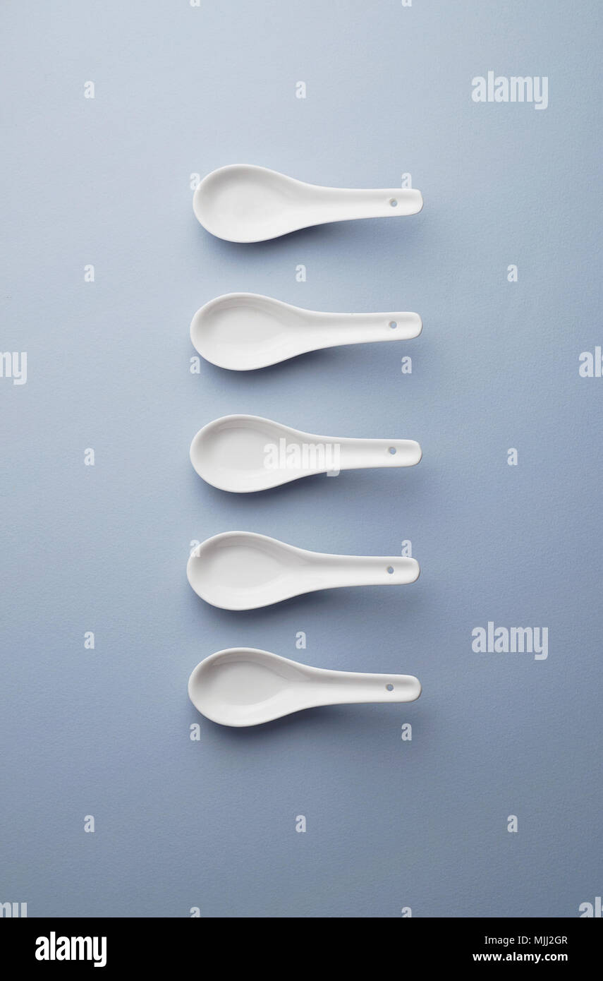 Collection of chinese soup spoons over blue background, above view Stock Photo Alamy