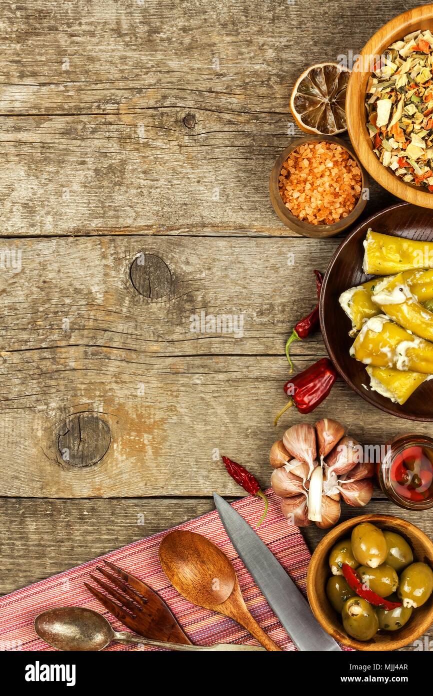 Food ingredients on a wooden background. Place for text. Restaurant menu.  Recipe for chefs. Spices and stuffed green olives Stock Photo - Alamy