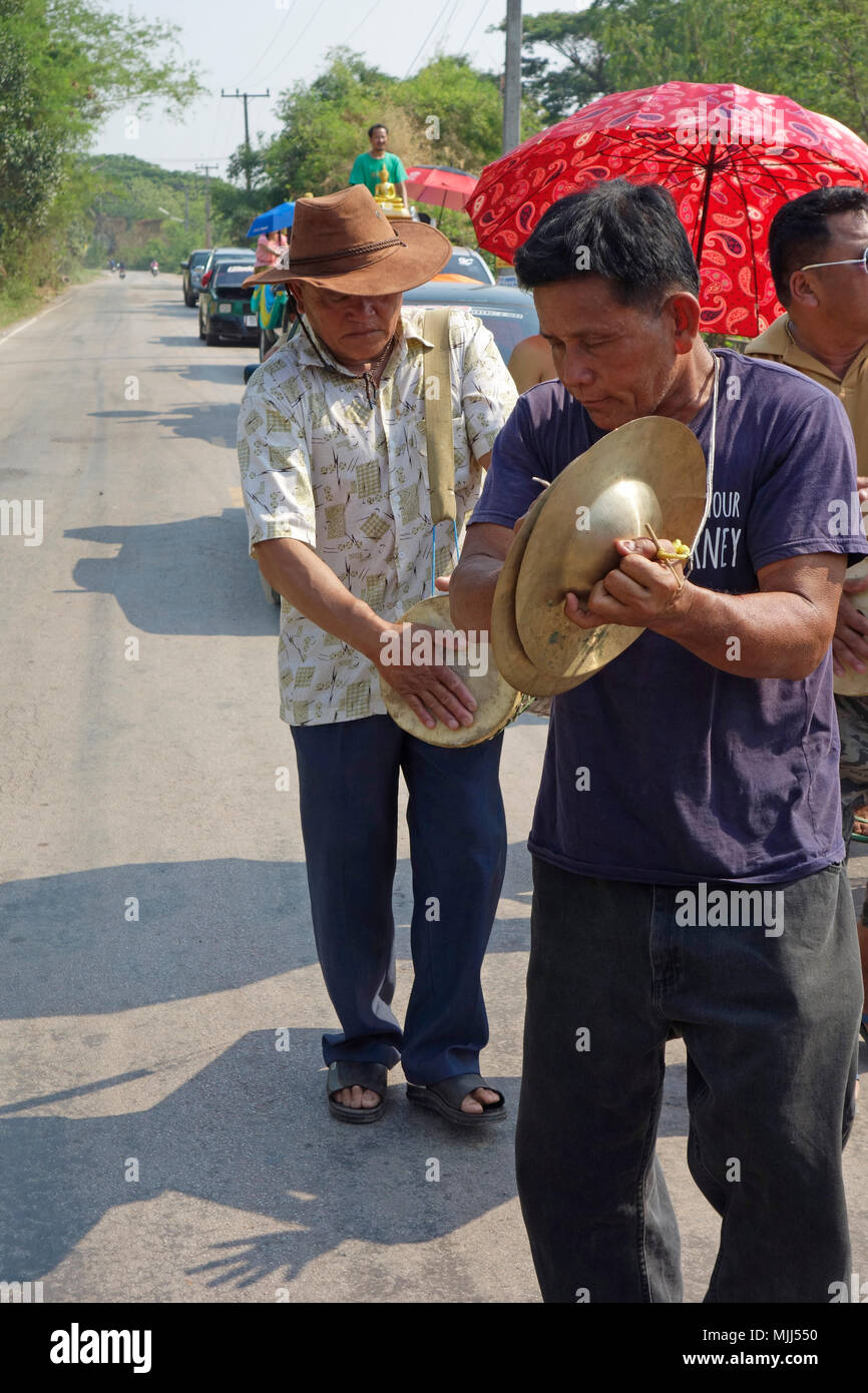 Songkran Thai New Year celebrations, street parade with street musicians playing chap yai cymbals and klong yao long drum, Udon Than Stock Photo
