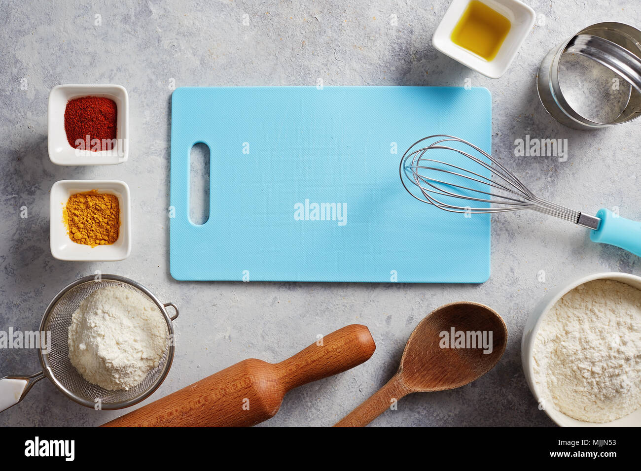 Various baking ingredients and utensils on the kitchen table. Stock Photo