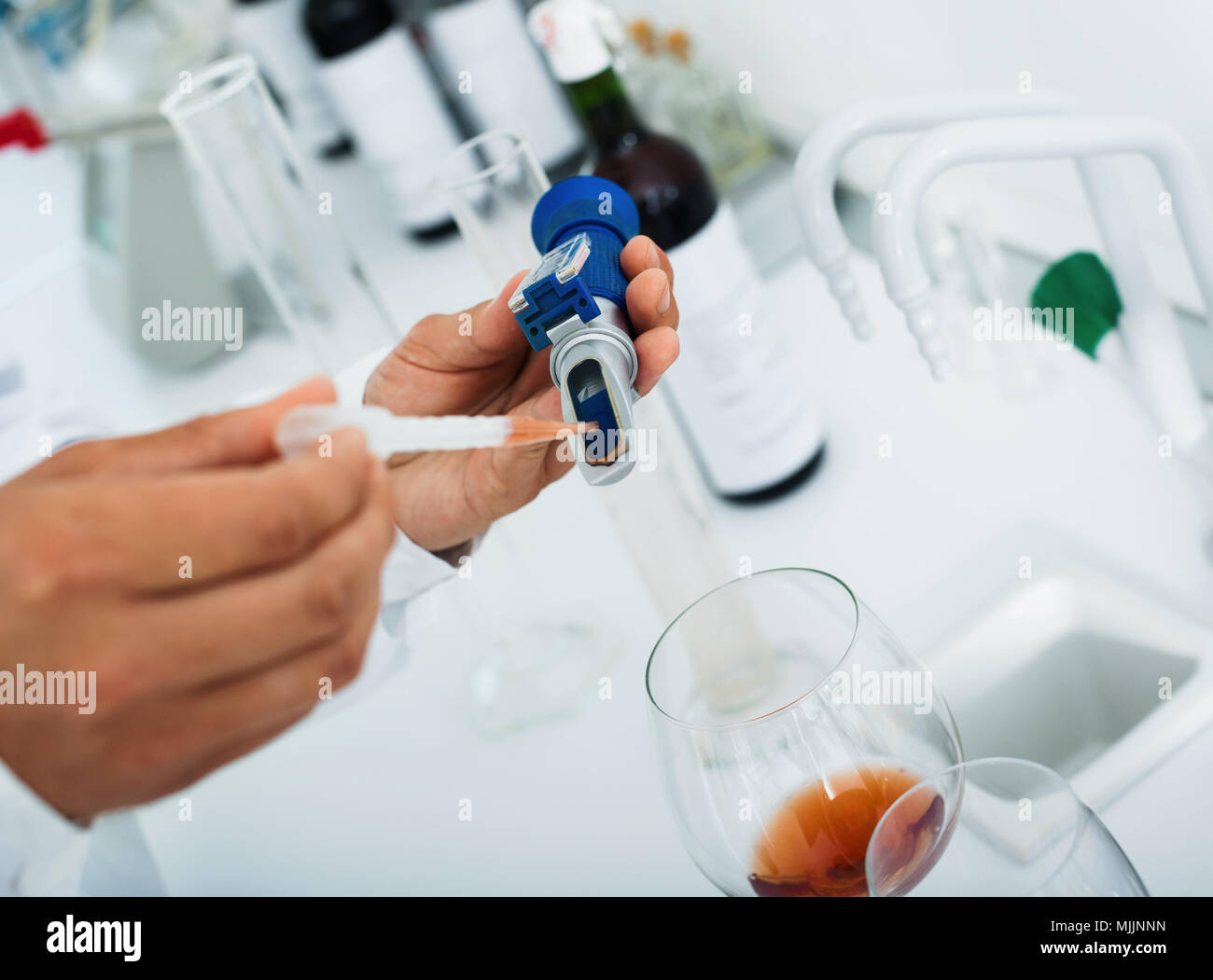 View on hands working in chemical laboratory checking wine qualities