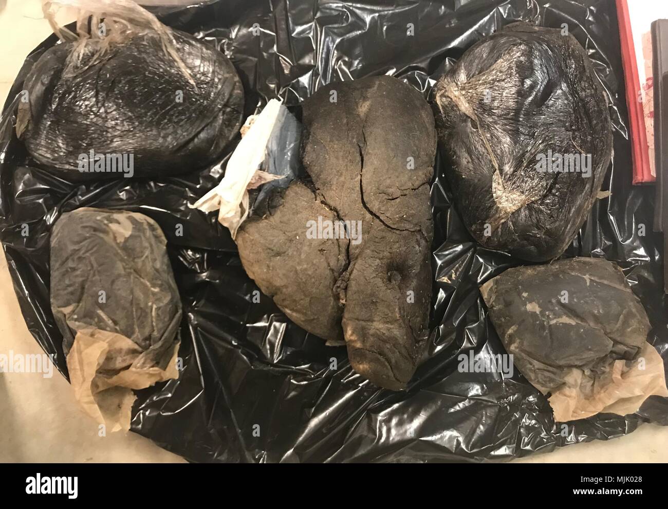 50kg of black tar heroin, valued at $4.6 million, was seized by the Afghan Special Security Forces during night raids in Sangin district, Helmand province, Afghanistan, Dec. 2-3, 2017. (U.S. Army photo) Stock Photo