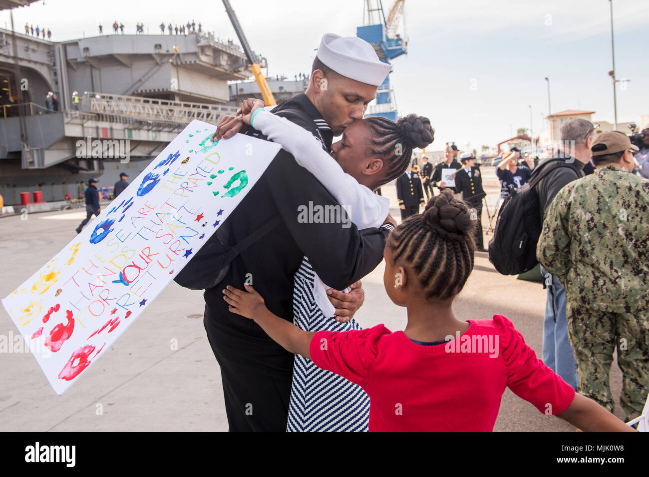 171205-N-BN355-0151  SAN DIEGO (Dec. 05, 2017) Aviation Maintenance Administrationman 1st Class Corey Oliver hugs his daughter after returning from deployment aboard USS Nimitz. The Nimitz Carrier Strike Group is on a regularly scheduled deployment to the Western Pacific. The U.S. Navy has patrolled the Indo-Asia-Pacific region routinely for more than 70 years, prompting peace security. (U.S. Navy photo by Mass Communication Specialist Seaman Apprentice Jailene Casso/Released) Stock Photo