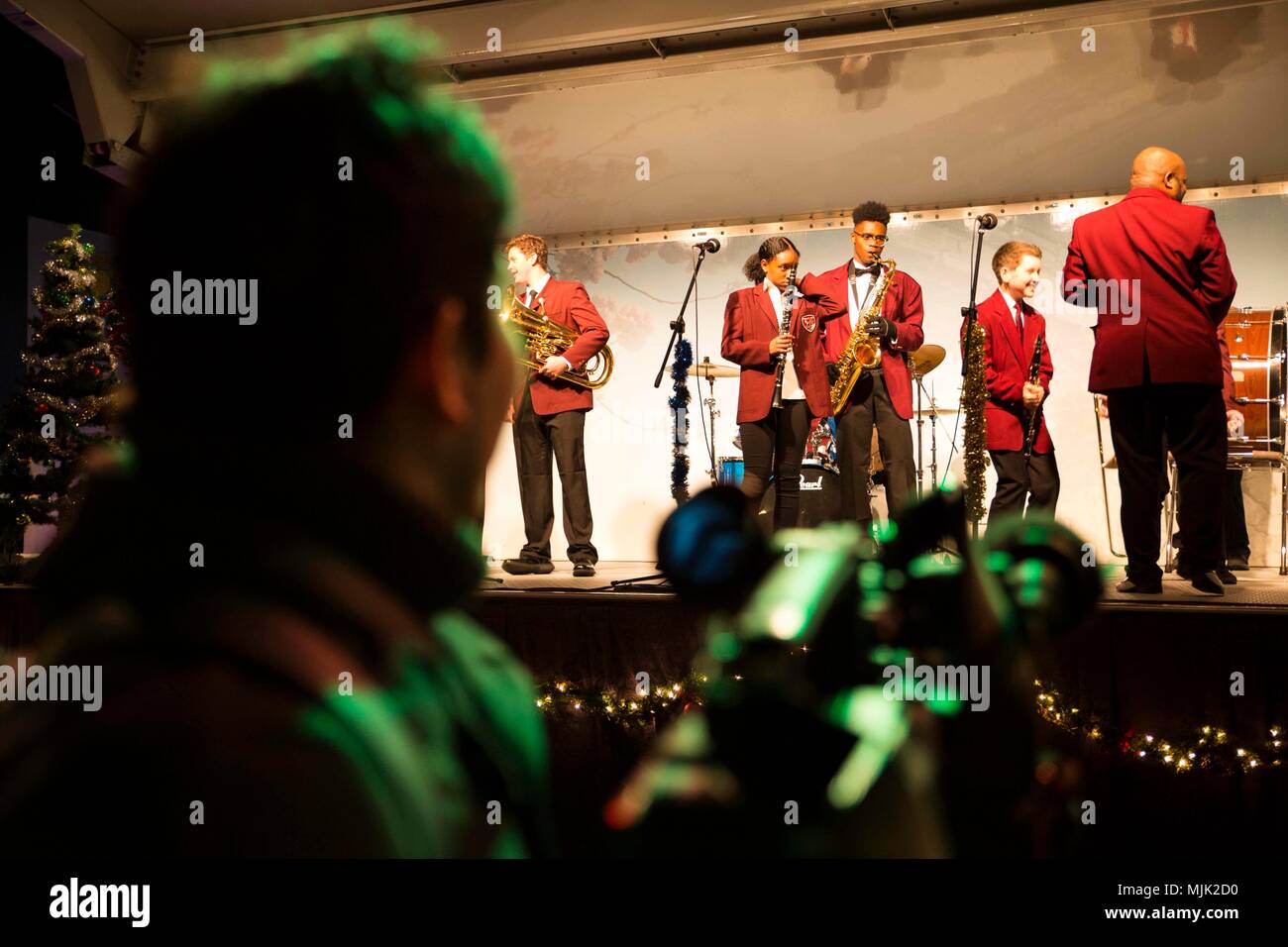 Local Japanese media takes video of a Mathew C. Perry High School Band  performance during a holiday tree lighting at Marine Corps Air Station  Iwakuni, Japan, Dec. 2, 2017. The tree lighting