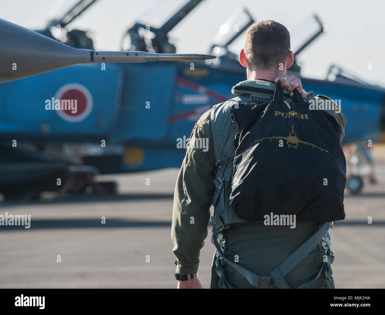 U.S. Air Force Maj. Richard Smeeding, the Pacific Air Forces F-16 Demonstration team pilot, carries his helmet bag to his jet at Japan Air Self-Defense Force Nyutabaru Air Base, Japan, Dec. 1, 2017. The team arrived almost a week prior to the Nyutabura Air Show, to ensure proper preparation for the two-day air show and to execute a training scenario alongside Nyutabaru AB's F-15Js. The PACAF Demo Team based at Misawa Air Base, Japan, promotes positive relations between the United States and nations across the Indo-Asia-Pacific region. (U.S. Air Force photo by Senior Airman Brittany A. Chase) Stock Photo