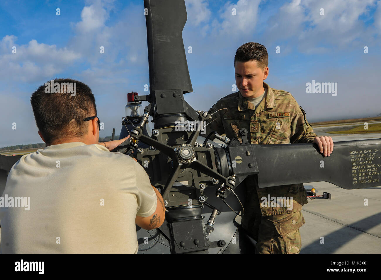 Senior Airman Greggory Petkewicz, and Senior Airman Trevor Krutch, 723d Aircraft Maintenance Squadron crew chiefs work on the rotor of an HH-60G Pave Hawk helicopter, Dec. 5, 2017, at Moody Air Force Base, Ga. As part of a Phase 1, Phase 2 exercise, the 23d Wing is evaluating its operations, maintenance and logistics to determine its readiness to rapidly deploy. Airmen from the 723d Aircraft Maintenance Squadron folded the main and tail rotor blades inward to make it easier to transport and then unfolded the rotors to practice making the helicopter operational.  (U.S. Air Force photo by Airman Stock Photo