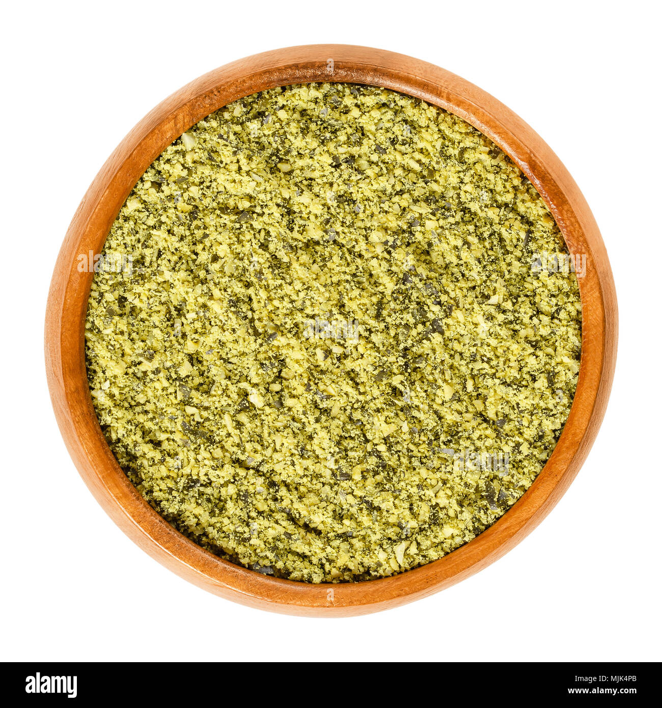 Ground pepita pumpkin seeds in wooden bowl, used for baking. Raw and