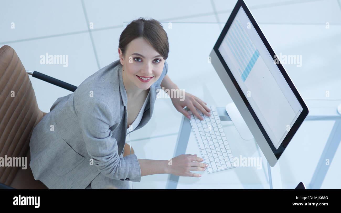 two business women sitting at Desk and looking at camera Stock Photo ...