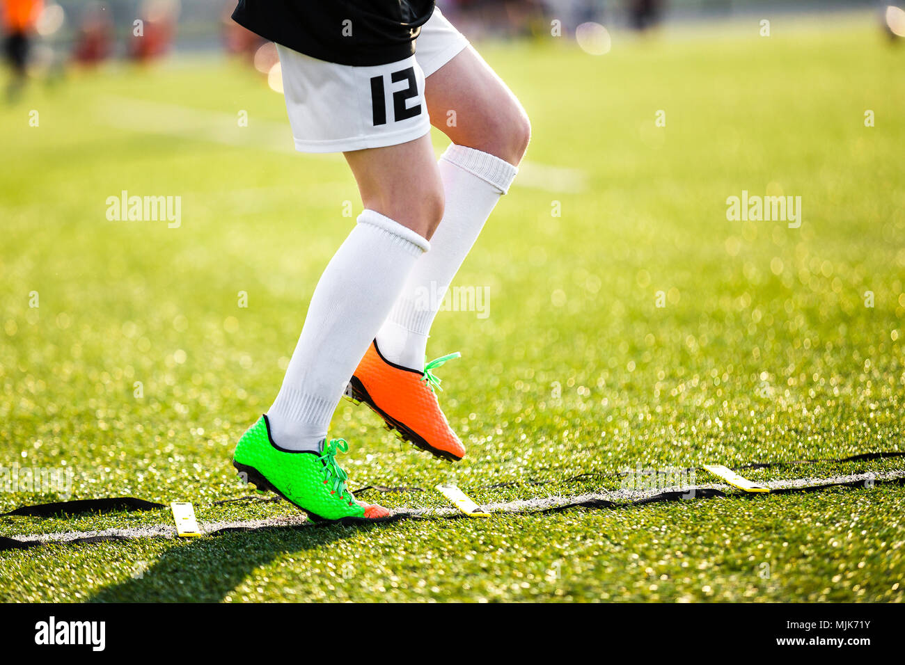 Boy Football Player on a Training with Ladder. Young Soccer Player at Training Session. Soccer Speed Ladder Drills. Training Drills To Improve Speed Stock Photo