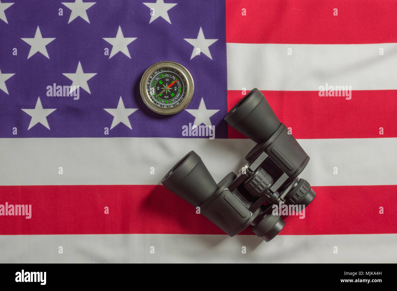 Binocular and compass on US flag Stock Photo